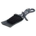 Hearth brush nested in a shallow pan, with crook-shaped handles, a projecting curved rest and a dark finish with silver stippling.