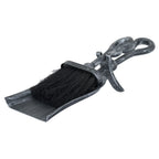 Hearth brush nested in a shallow pan, with crook-shaped handles, a projecting curved rest and a dark finish with silver stippling.