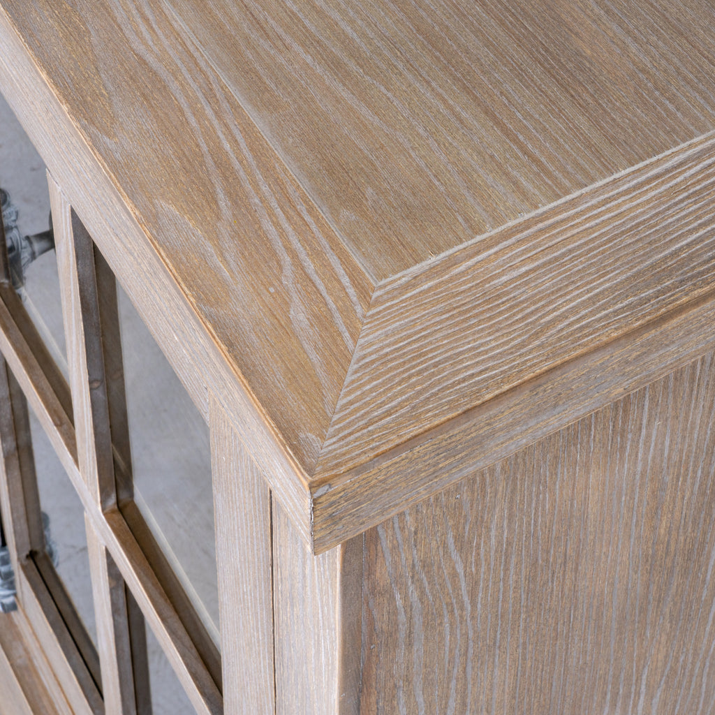 Close-up from above of the sideboard's projecting top corner, showing the border lines and white-highlighted grain.