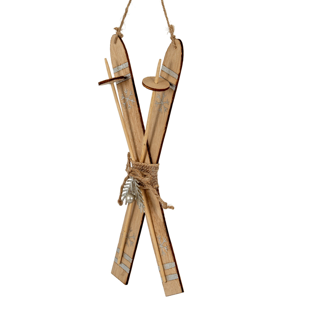 Angled view of the crossed skis showing their dark edges, slender pole forms with circular discs, and silver-coloured snowflake decoration.