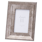 Angled view of a portrait photo frame with a broad sloping silver-grey surround, distressed linear markings and a white dream BIG placeholder.
