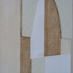 Close-up of raised granular cream panels beside white woven-looking areas and ochre-brown crosshatching around the central arch.