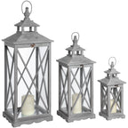 Three grey wooden lanterns in descending sizes, each with crossed side bars, a tiered roof, a top loop and a cream candle pictured inside.