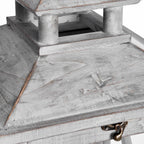 Close view of the lantern's pitched roof and open upper tier, showing the rubbed grey wood finish and bronze-toned front catch.