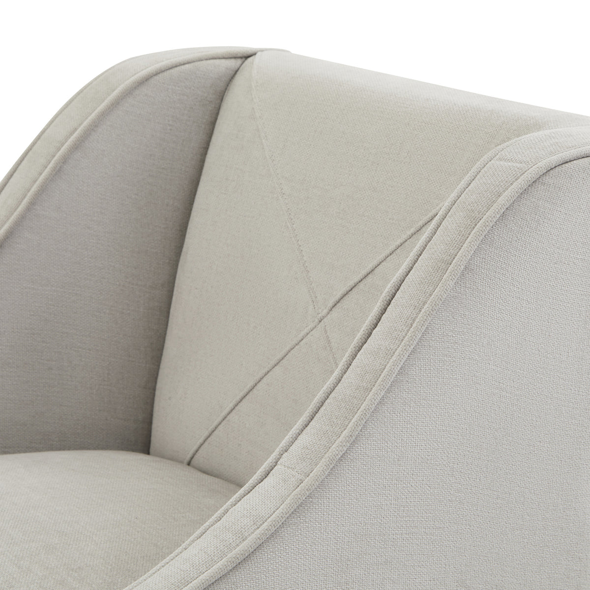 Close-up of the stool's pale textured covering, diagonal back stitching and piping along the curved arm.