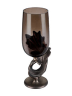 Rear view showing the rounded smoked-glass vessel and the open loop in the bronze-toned base.