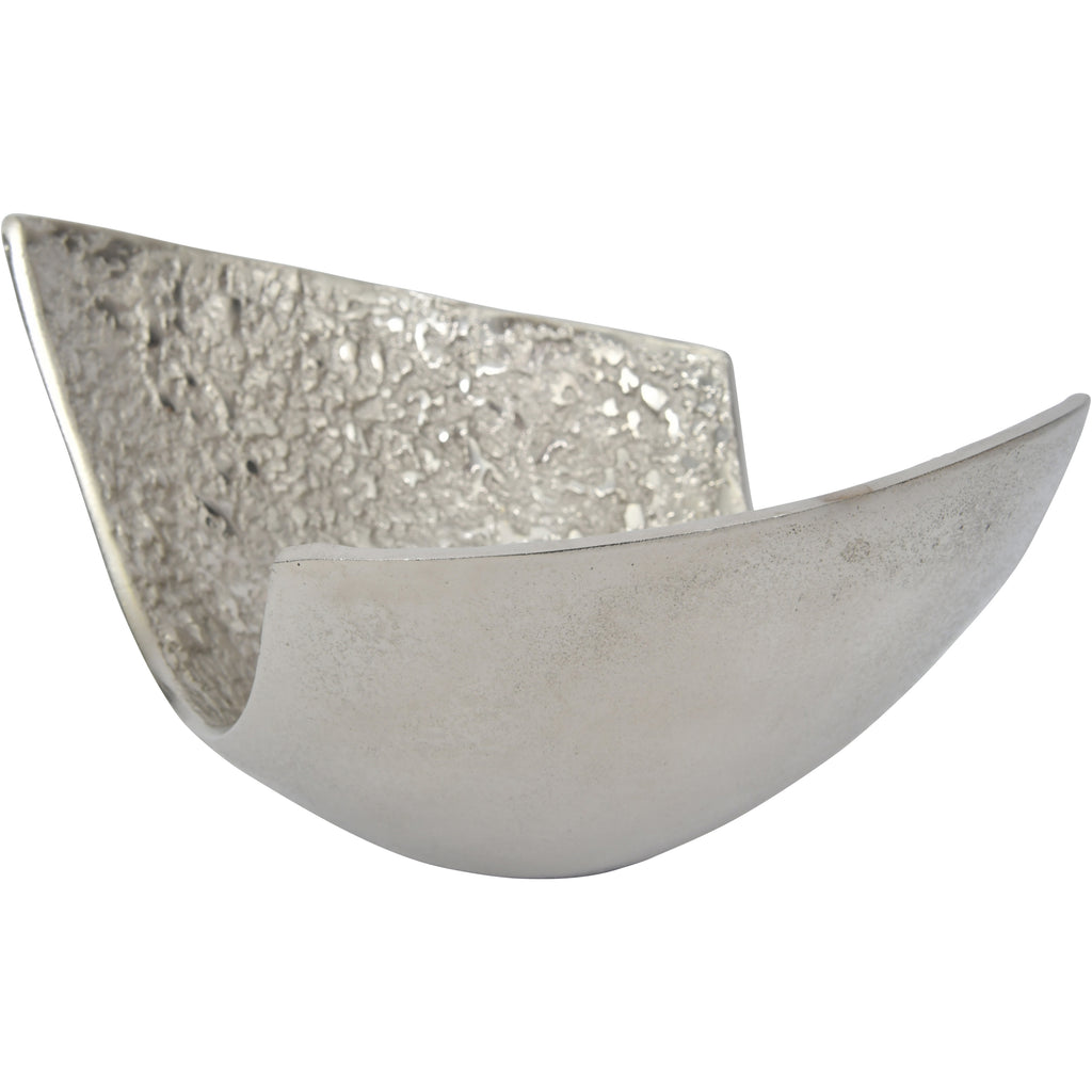 Angled side view of the silver-coloured bowl, with a smooth curved exterior in front of the textured inner surface.