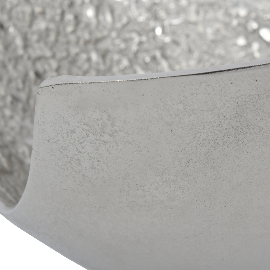 Close-up of the smooth outer wall and rim, with fine surface markings and the textured interior behind.