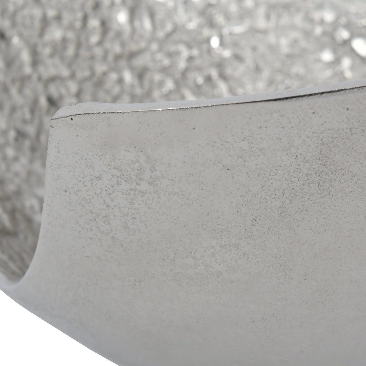 Close-up of the smooth outer wall and rim, with fine surface markings and the textured interior behind.