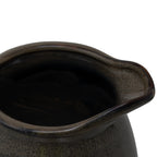 Close-up looking into the vase's irregular oval opening, showing the rolled rim, projecting lip and mottled olive-brown finish.
