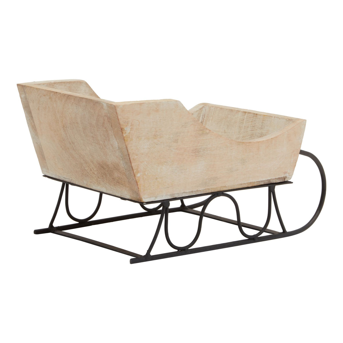Rear three-quarter view of the decorative sleigh showing its tall back panel, pale grain-like markings and black looped supports.
