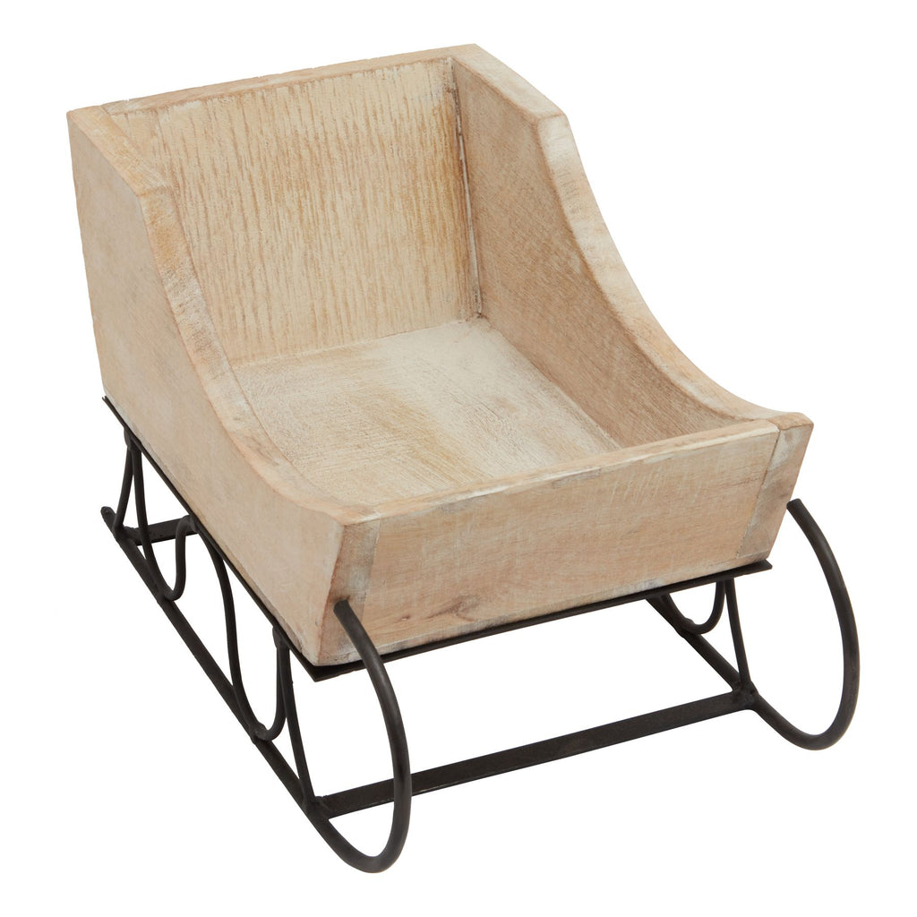 Angled view into the empty sleigh body showing the pale whitewashed interior, curved side edges and black runner curls below.