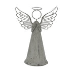 Front view of a weathered grey standing angel with folded hands, a long conical robe, circular head and halo, and broad wings with curled outlines.