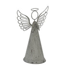 Angled view of the grey angel decoration showing the curved robe, dark flecks across its surface and open curled wings rising beside the loop-shaped head and halo.