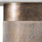 Detail of the champagne gold column beneath the marble top, showing a smooth mottled band above fine vertical fluting.