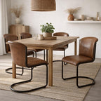 Brown curved dining chairs arranged around a pale wood table on a woven rug, with a plant centrepiece and woven pendant shade.