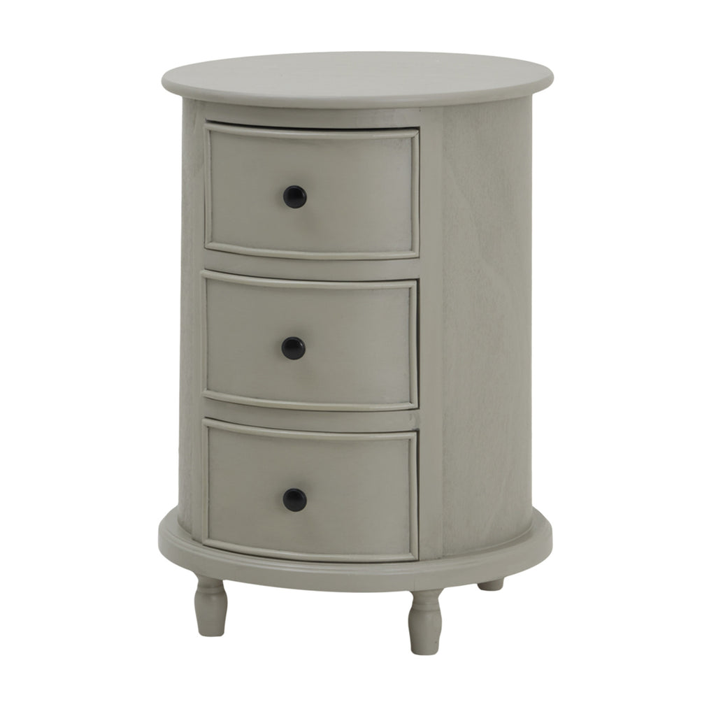 Pale grey cylindrical side table on a white background, with three curved framed drawer fronts, dark round knobs and short shaped feet.