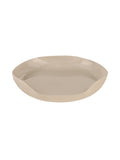 Cream decorative tray viewed at an angle, showing its irregular outline and glossy interior.