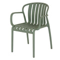 Three-quarter front view of a muted sage-green dining chair with open rounded arms, six curved slats and four legs.