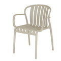 Three-quarter view of a warm putty dining chair with open rounded arms, six curved slats and four legs on a white background.