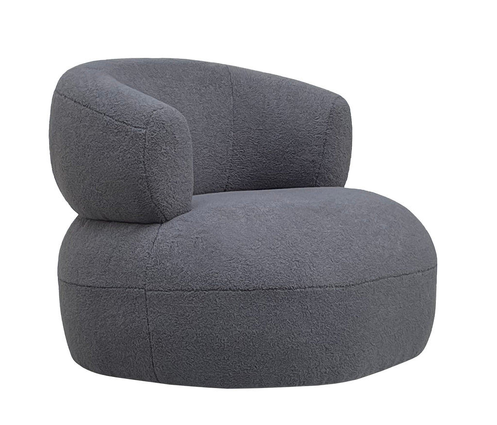 Three-quarter view of the grey bouclé armchair showing the wraparound back and rounded upholstered base.