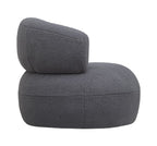 Side view of the grey bouclé chair showing its thick curved back above the rounded seat.