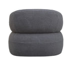 Rear view of the grey bouclé armchair with a rounded upholstered back and visible panel seams.