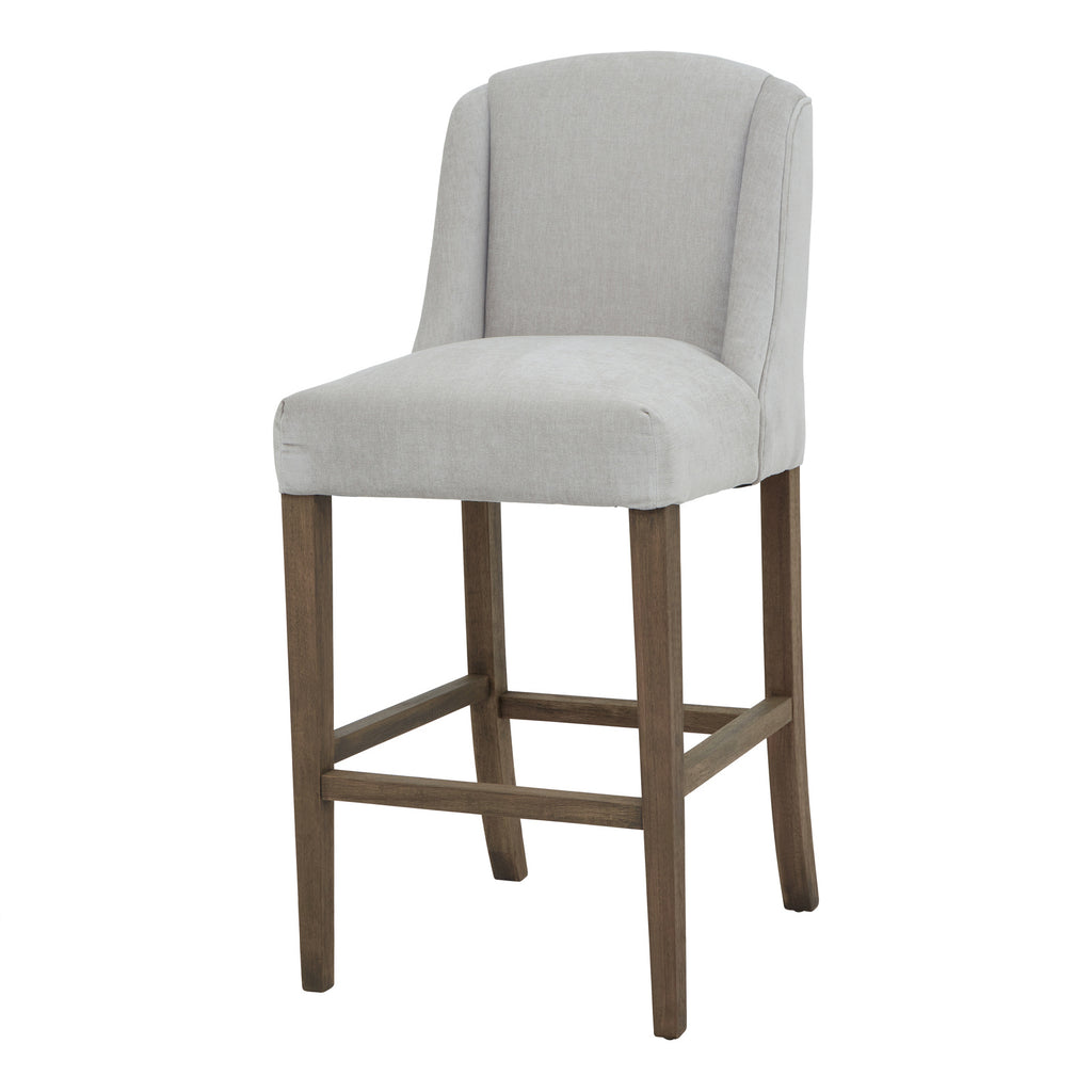 Front three-quarter view of a pale grey bar stool with a curved winged back, brown legs and rectangular lower rails.