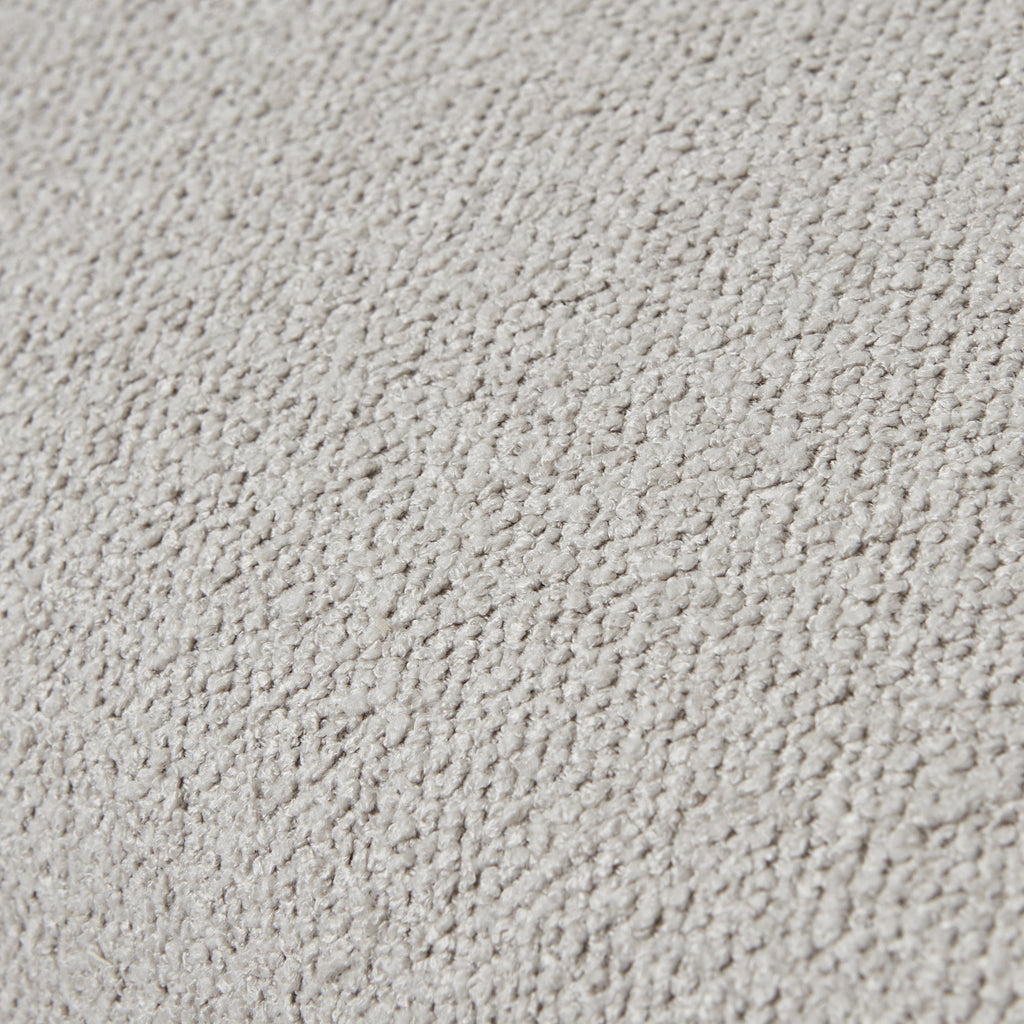 Tight close-up of the neutral upholstery showing its small raised loops and uneven surface texture.
