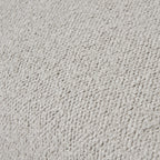 Tight close-up of the neutral upholstery showing its small raised loops and uneven surface texture.