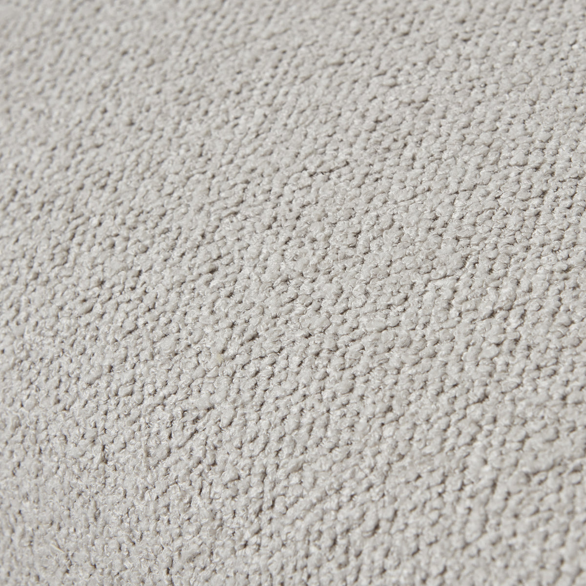 Tight close-up of the neutral upholstery showing its small raised loops and uneven surface texture.