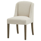 Front angled view of a cream loop-textured dining chair with a tall curved wing back, padded seat and four brown legs.