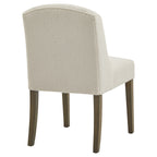 Rear angled view of the dining chair showing its cream textured back, curved top edge and brown legs.