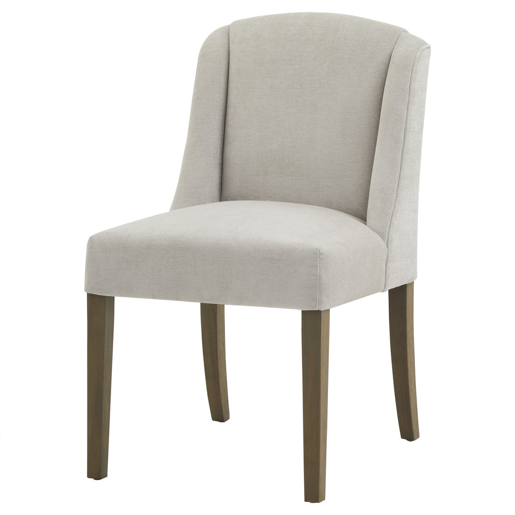 Front three-quarter view of a pale grey dining chair with curved side wings, a rounded seat and four brown legs on a white background.