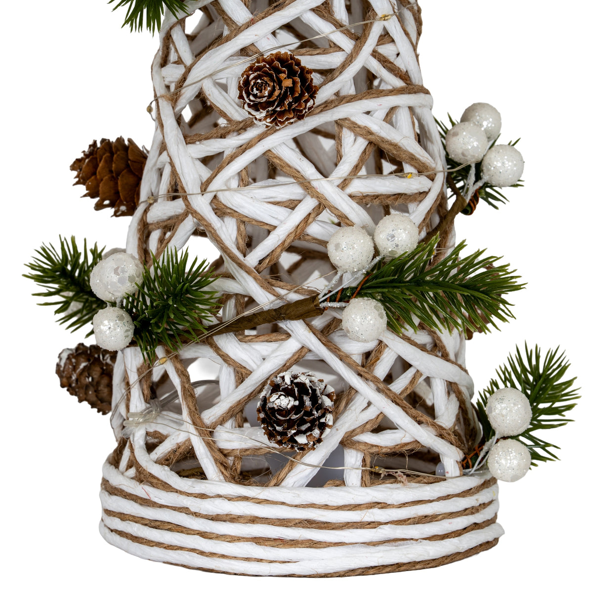 Close-up of the tree's lower lattice and banded foot, showing pinecones, glittery white berries, green pine sprays and fine wire with small LED nodes.