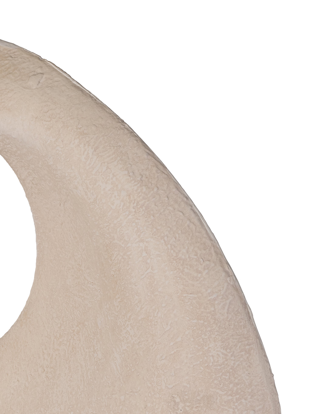 Close-up of the sculpture's cream textured surface, curved outer edge and part of an oval opening.