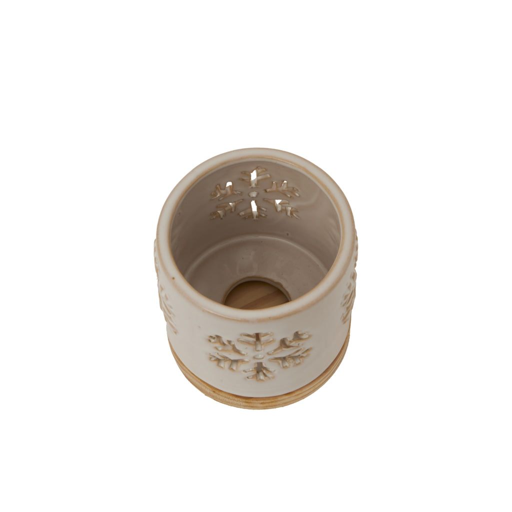 View into the snowflake candle holder from above, showing the cream interior, pierced sides and circular opening at the bottom.