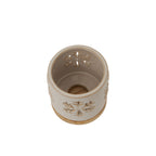 View into the snowflake candle holder from above, showing the cream interior, pierced sides and circular opening at the bottom.