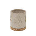 Cream cylindrical candle holder with a snowflake motif facing forward and a round grain-patterned base.