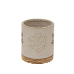 Cream cylindrical candle holder with a snowflake motif facing forward and a round grain-patterned base.