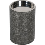 View from above of the empty candle holder, showing its reflective recessed interior and textured sides.