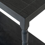 Close-up of the dark console table's top corner and leg, showing fine grain texture, the straight apron and rounded leg profile above the lower shelf.