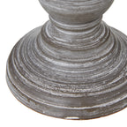 Detail of the lamp's stepped circular foot with pale rubbed highlights following the concentric ridges