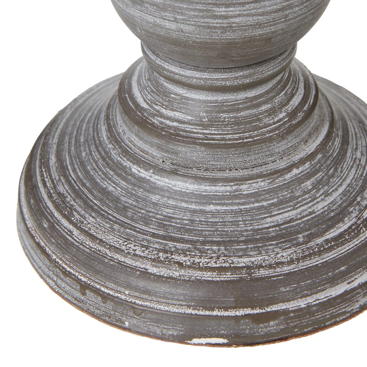 Detail of the lamp's stepped circular foot with pale rubbed highlights following the concentric ridges