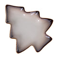 Overhead view of a tree-shaped decorative dish with a pale speckled centre, dark border and narrow tan edge.
