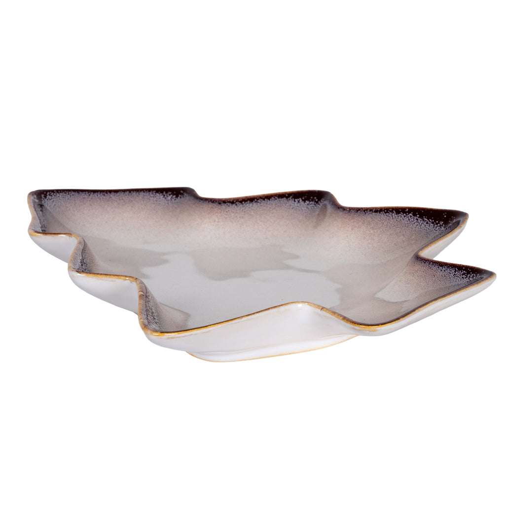 Low angled view of the shallow tree-shaped dish, showing its raised branch-shaped rim, glossy interior and pale outer sides.