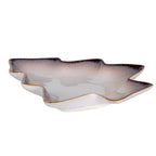 Low angled view of the shallow tree-shaped dish, showing its raised branch-shaped rim, glossy interior and pale outer sides.