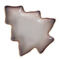 Overhead view of a tree-shaped decorative dish, with a pale speckled basin, dark stepped rim and fine tan edging.