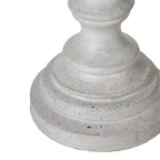 Detail of the lamp's curved lower stem and stepped circular foot with pale grey-white colouring and darker surface marks.