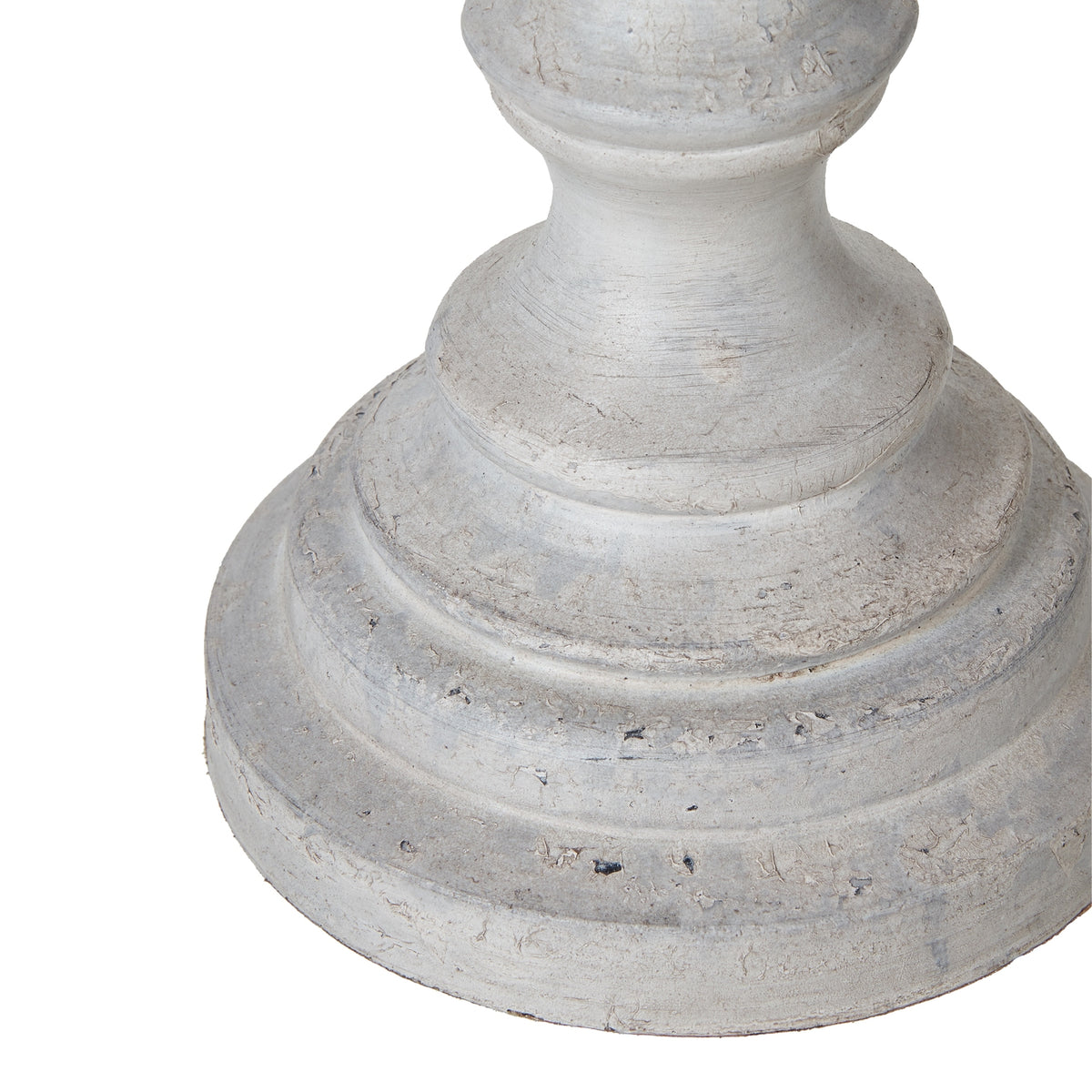 Detail of the lamp's curved lower stem and stepped circular foot with pale grey-white colouring and darker surface marks.